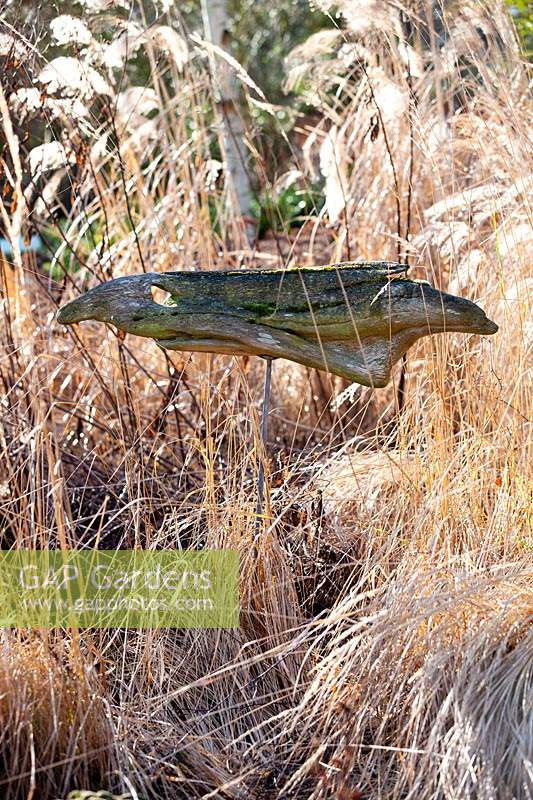 A Driftwood dolphin sculpture, in the Hepworth Garden, based on her painting Green Caves 1946, Stevington Manor Gardens, Stevington, UK.

