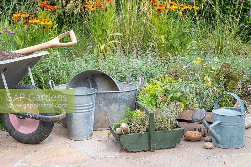 Materials and tools for creating a tiered tin Herb planter. 