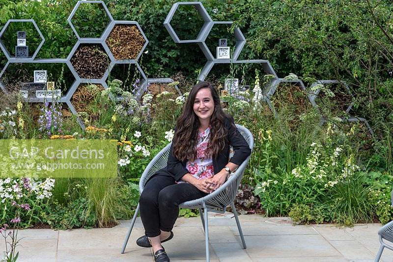 Caitlin McLaughlin has designed a garden that focuses on plants to encourage pollinators - A wall made from honeycomb shapes contains twigs to encourage solitary bees.