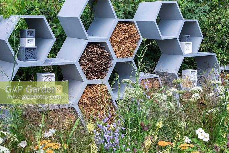 A wall made from honeycomb shapes containing twigs to encourage solitary bees. 