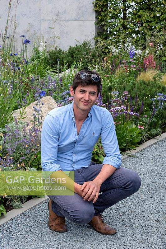Garden designer Will Williams beside one of the wildlife-friendly borders in a contemporary garden 