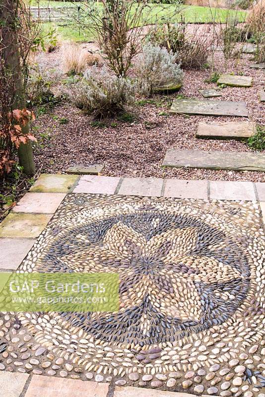 Pebble mosaic in the shape of a flower at Ellicar Gardens, Doncaster, UK. 