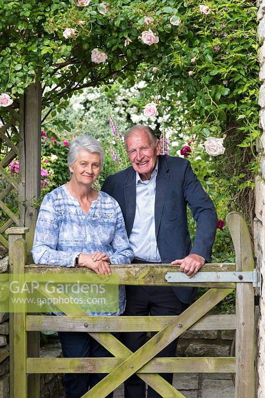 Colin and Erica McGarrigle at the gate of their walled rose garden.