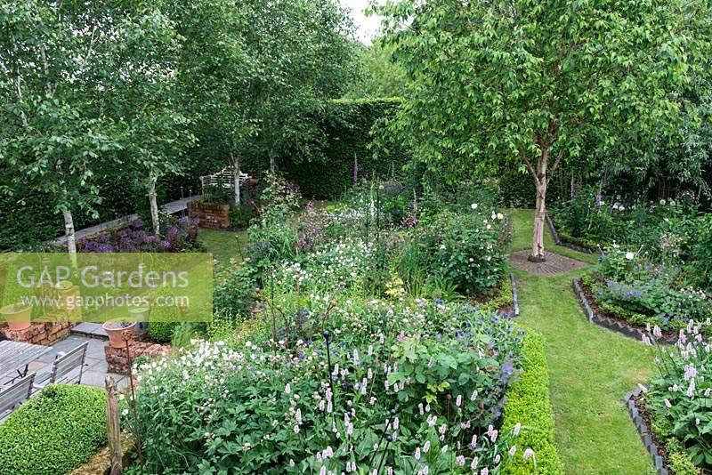 An 18m square area enclosed in tall hornbeam hedges. A box parterre is planted with Bistort, hardy Geraniums, Centaurea, Foxgloves, ragged robin, Alliums, Astrantias, Aquilegias and Roses, with Silver birches adding height.