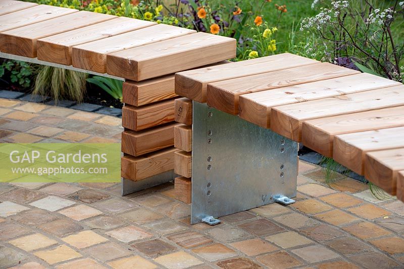 Curved wooden benches  on brick paving - The Redshift, RHS Malvern Spring Festival 2019