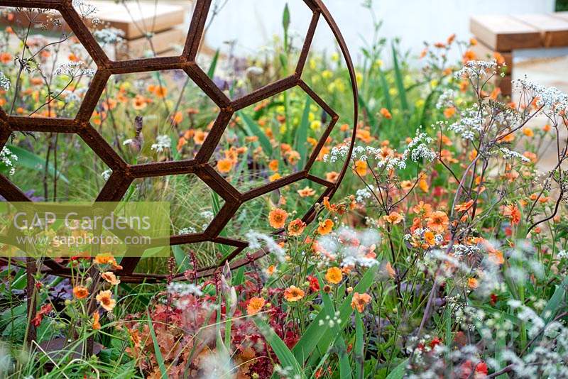 Rusted metal sculpture by Julie Grose Metal Design in a mixed spring border - The Redshift, RHS Malvern Spring Festival 2019