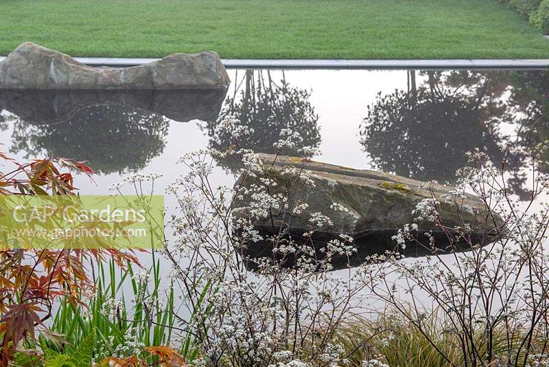Anthriscus sylvestris 'Ravenswing' next to a reflective pool with split boulders - The Leaf Creative Garden - A Garden of a quiet contemplation - RHS Malvern Spring Festival 2019