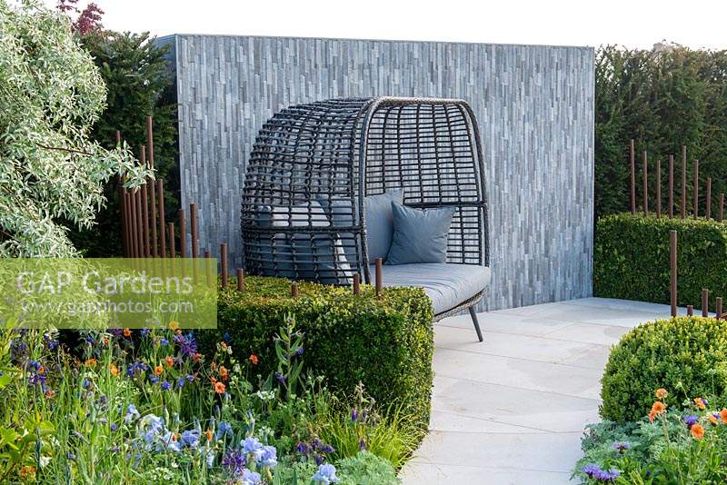 Curved box hedge surrounded a seating area with feature porcelain wall - The Habit of Living - A Garden in support of Diabetes UK, RHS Malvern Spring Festival 2019