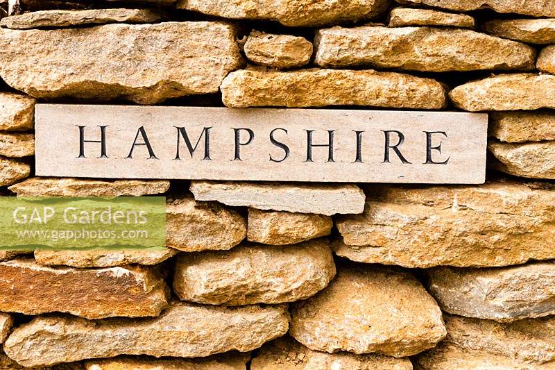 'Hampshire' plaque set into the wall identifying the origin of nearby apple trees