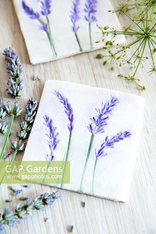 Decorative tiles made from salt dough and pressed and painted lavender flowers 
