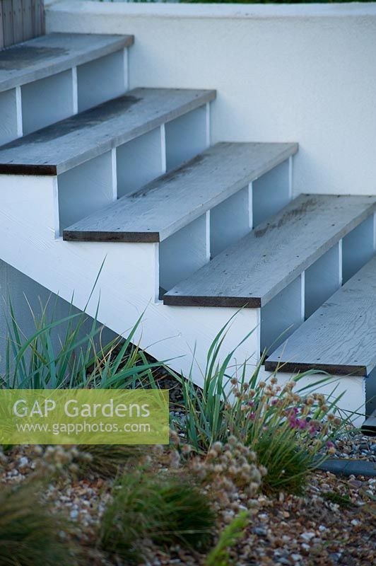 Contemporary steps in modern, seaside garden.