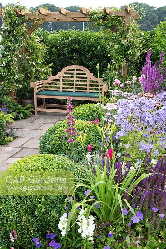 Seating area and colourful flowerbeds in The Art and Nature of a Port Sunlight Garden, Tatton Flower Show 2019