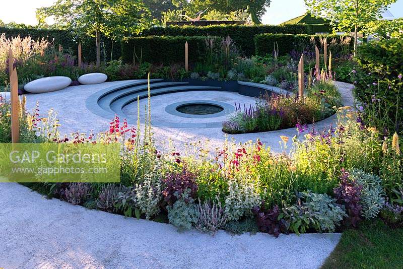 Spiralling pathway leading to a sunken seating area. RHS Hampton Court Flower Festival 2019.