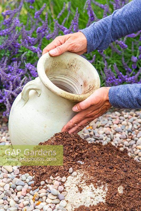 Woman placing urn in gravel