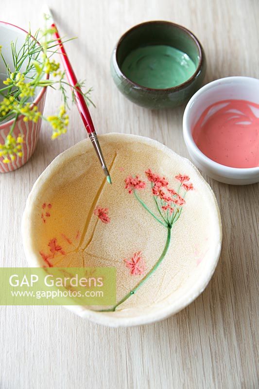 Freshly-painted flower imprints on a salt dough bowl

