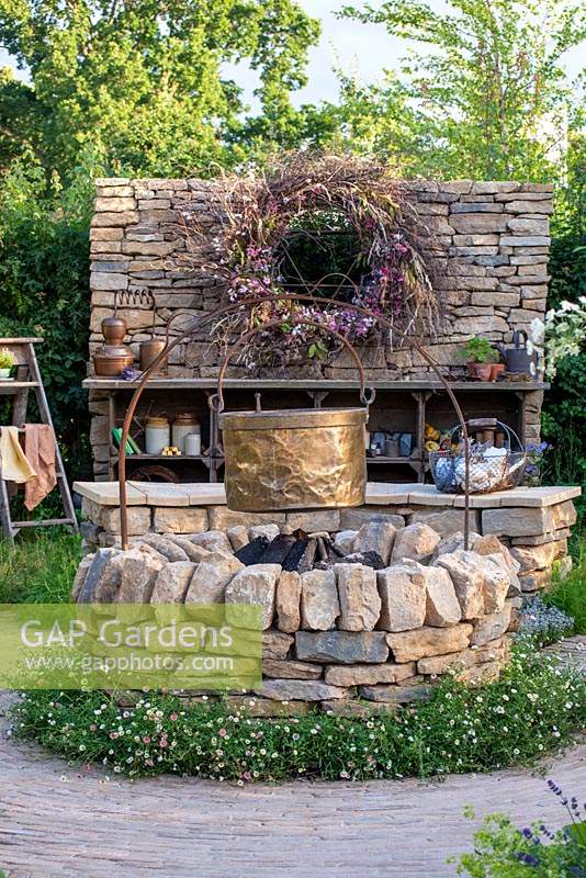 Cooking pot hanging over a firepit. RHS Hampton Court Palace Flower Festival 2019.