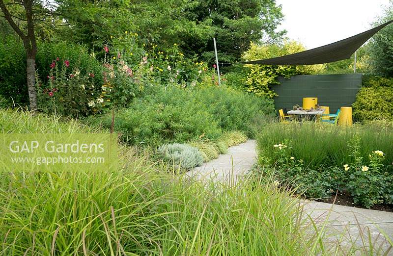 Overview garden with canvas sunscreen and seating area.
