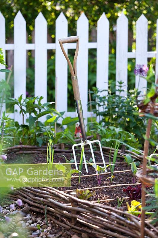 Garden fork in vegetable bed.