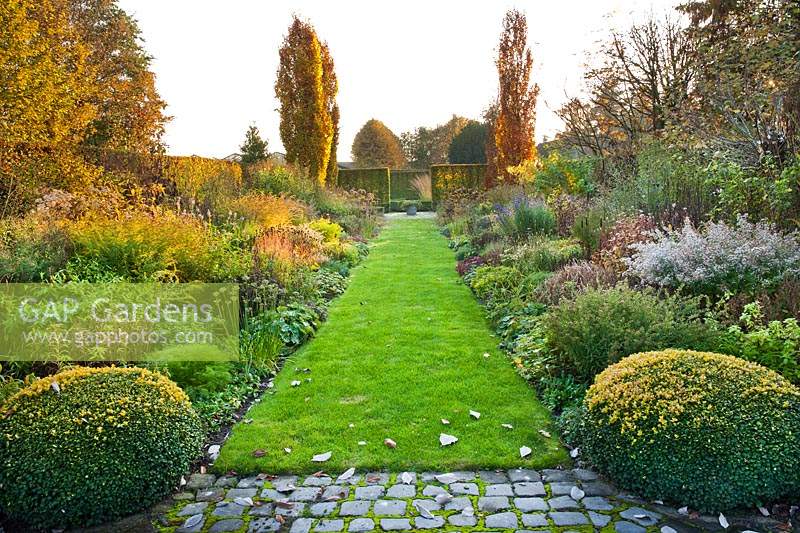 View up through double herbaceous borders separated by grass path