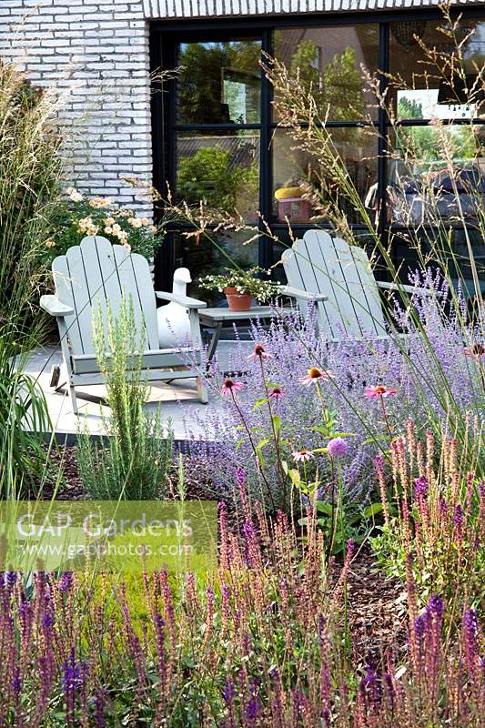 Relaxing area on patio and perennial flower border