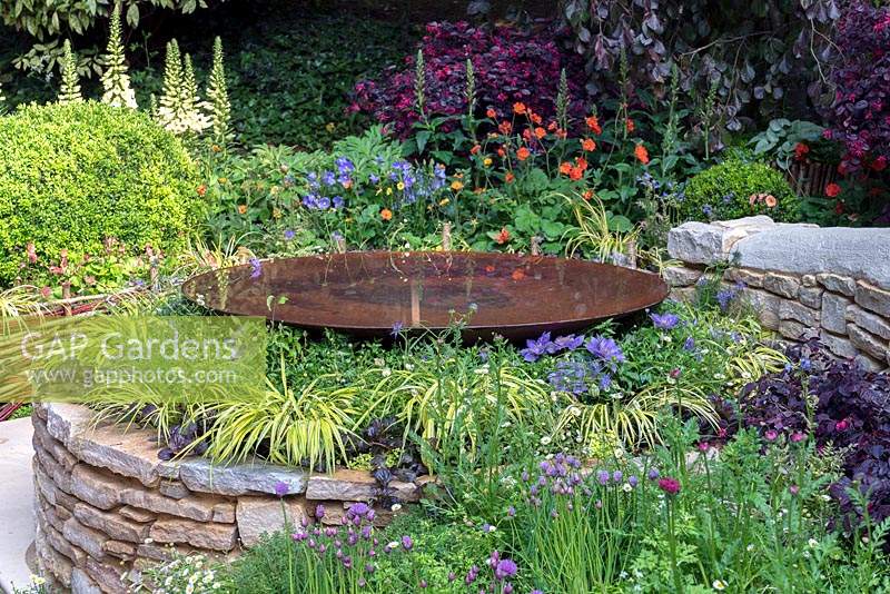 Circular Drystone raised bed with domed water dish in The Kingston Maurward Garden at RHS Chelsea Flower Show 2019