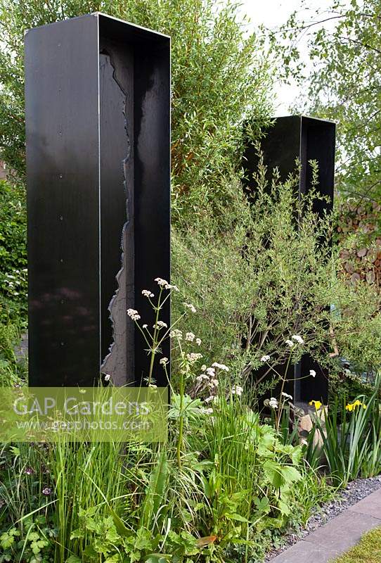 Viking Cruises: The Art of Viking Garden, planting in front of the black metal sculptures includes Valeriana officinalis and Salix. Sponsor: Viking.