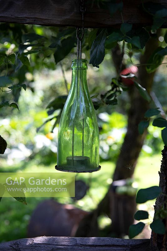 Recycled tea-light holder hanging from tree