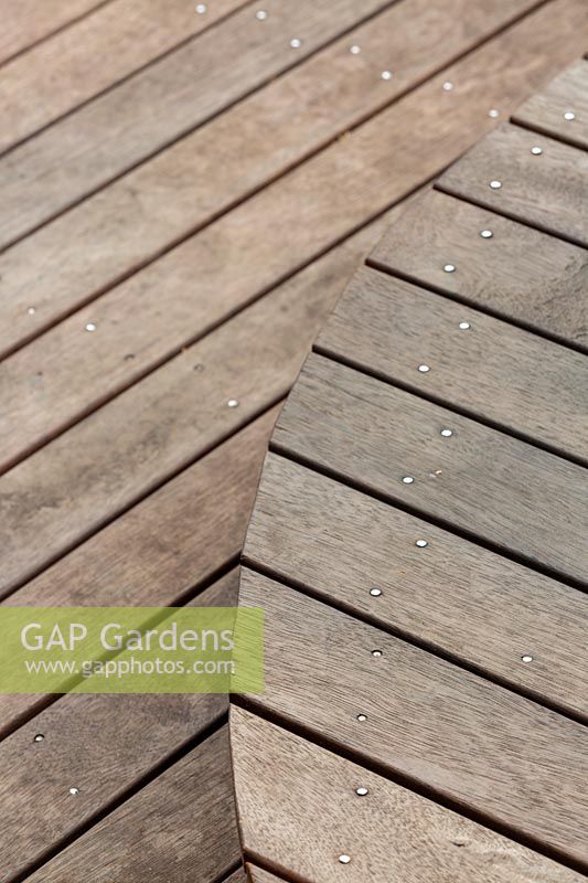 Detail of a curved hardwood timber deck showing level change.