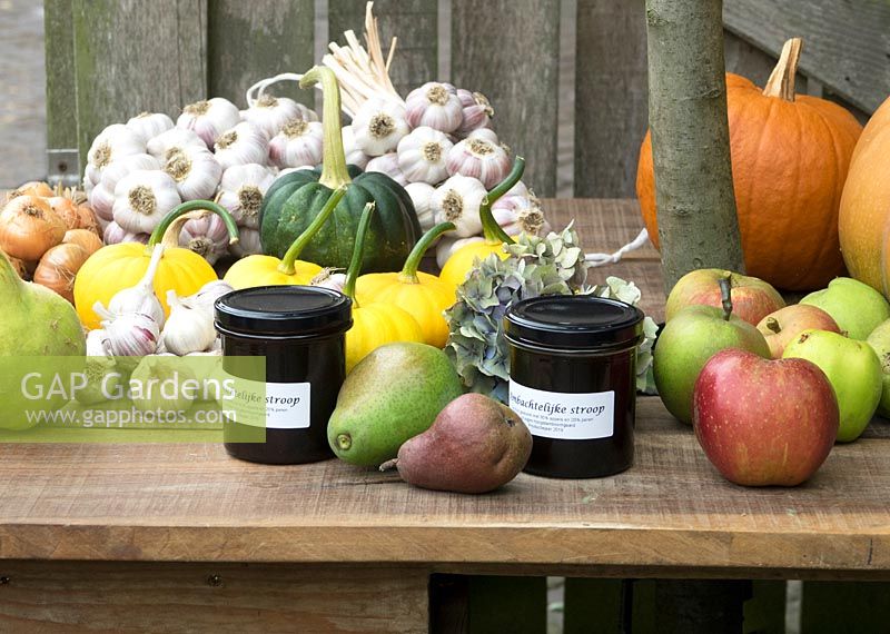 Jars of artisan preserves with apples and pears and edible produce for sale