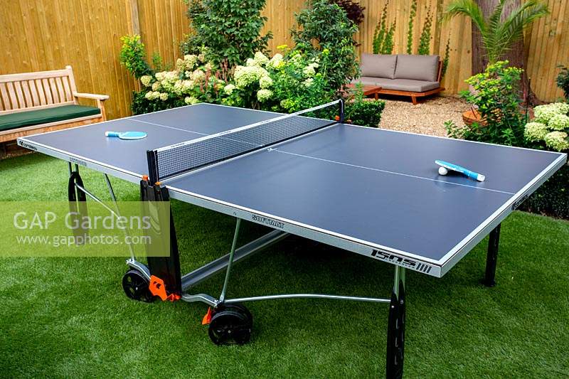 West London garden with table tennis table on artificial lawn.