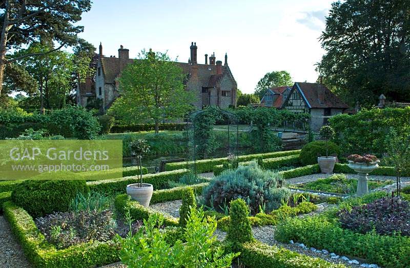 View of formal walled vegetable and fruit garden, with herb parterre at the centre - Hindringham Hall, Norfolk. 