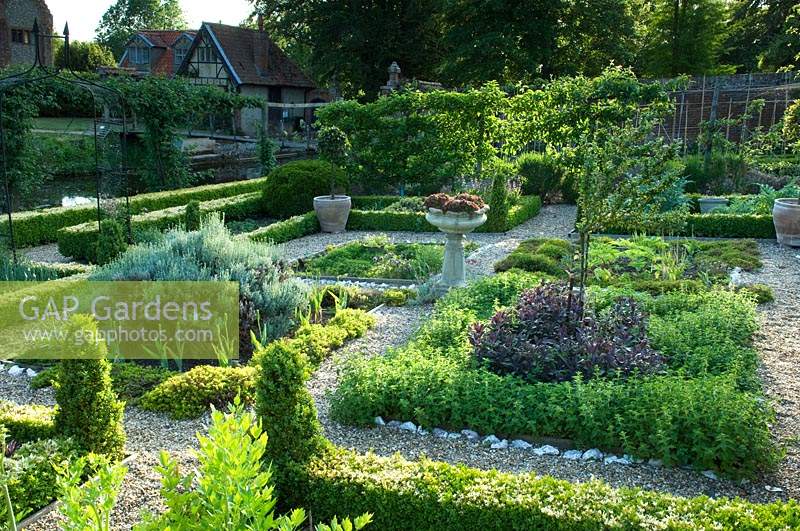 View of formal walled vegetable and fruit garden, with herb parterre at the centre