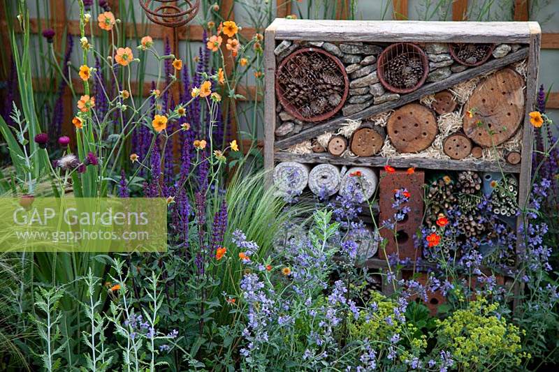 Bug hotel set amongst colourful perennials in the 'Split Screen' garden at BBC Gardenerer's World Live 2017