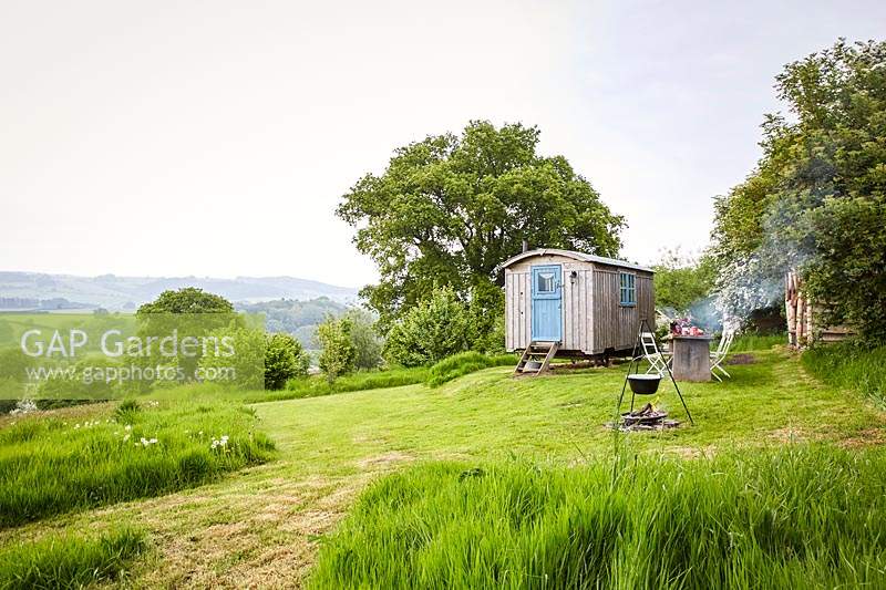 View to shepherds hut, outside dining area and cooking facility all set in Wild Meadows.