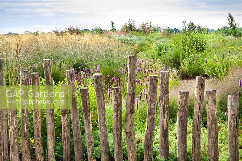 Wooden pole boundary to the prairie garden
