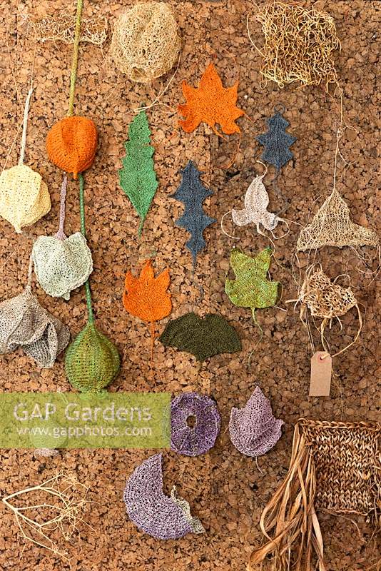 Alison Ellen Hand Knits studio - Cork board with hand knitted samples of leaves and seed heads and samples knitted with dried foliage.