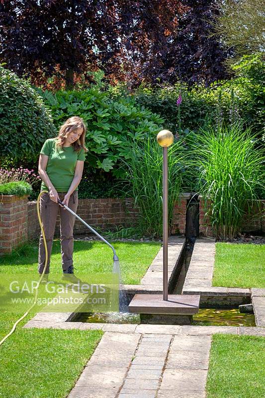 Topping up water features using a hosepipe