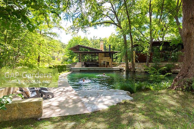 People swimming in the swimming pond at Mill Creek Ranch in Vanderpool, Texas designed by Ten Eyck Landscape Inc, July.