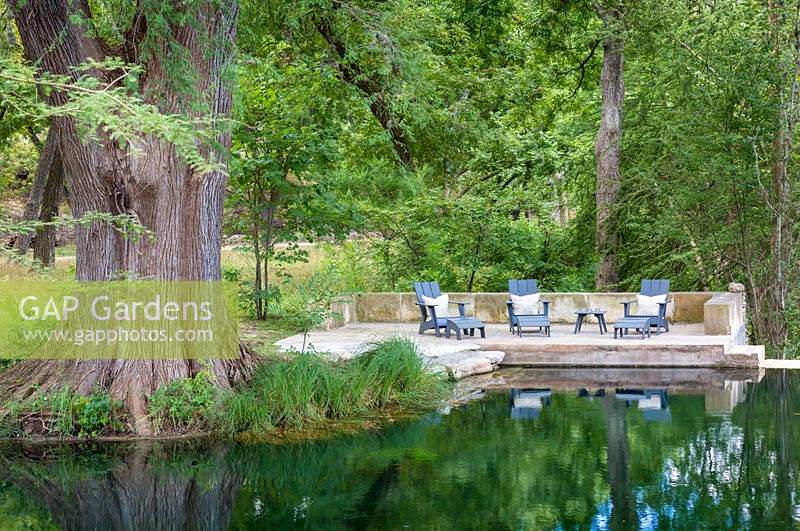 Relaxing area by the water in Mill Creek Ranch in Vanderpool, Texas designed by Ten Eyck Landscape Inc, July.
