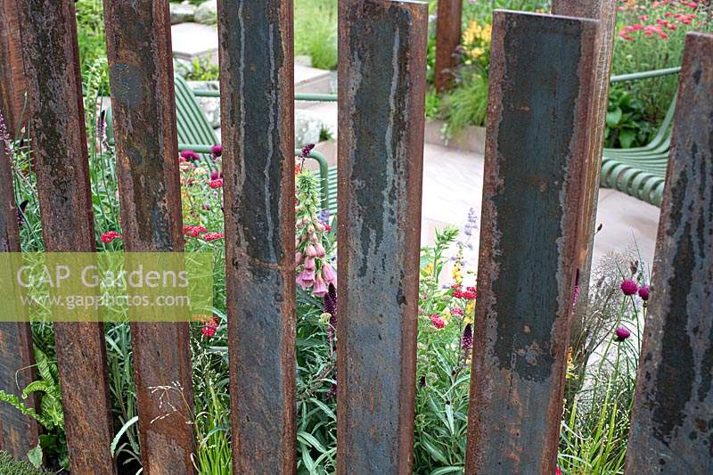 Corten steel fence in the 'Elements of Sheffield' garden at the RHS Chatsworth Flower Show 2019.