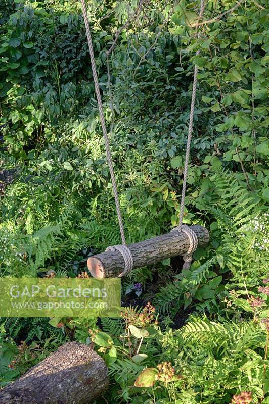 Log swing in wild garden. RHS Back to Nature. RHS Hampton Court Palace Garden Festival, 2019. - 