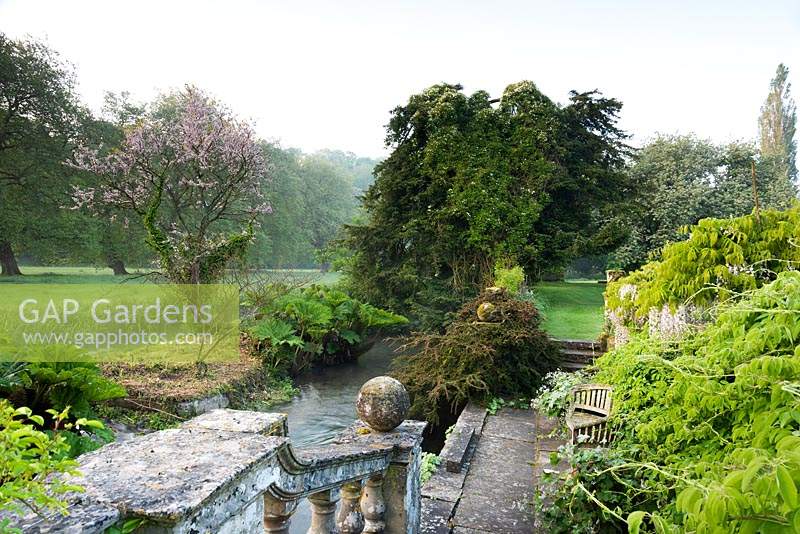 View from the boat terrace to water meadows beyond the river at Heale Gardens, Wiltshire, UK. 