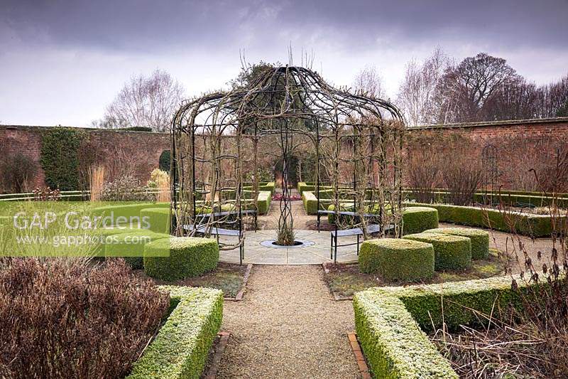 View over The Walled Garden, with metal gazebo and central 'Tree of Life', Ygdrassil - the Norwegian World Tree. Littlethorpe Manor, Yorkshire, UK. Designed by Eddie Harland.