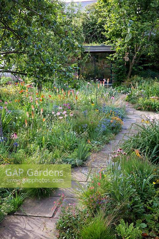View of mixed border and pathway leading to a garden room in Dr. James Hitchmough's garden, Sheffield. 