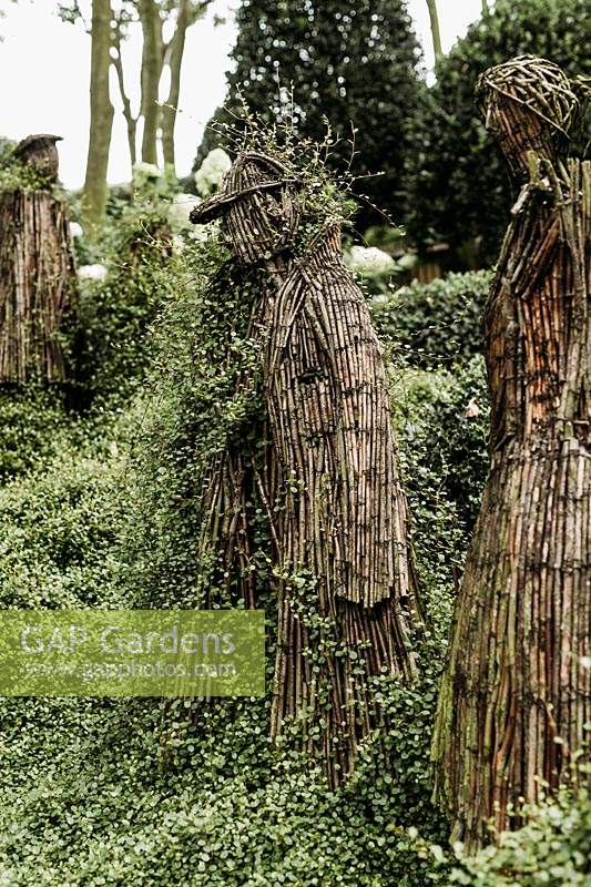 Wicker people by Agnieszka Gradzik and Wiktor Szostalo covered in Muehlenbeckia compactus. Les Jardins d Etretat, Normandy, France