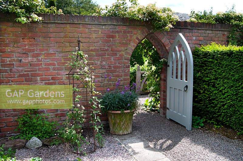 Secret door leading from the courtyard garden at Wollerton Old Hall Garden, Shropshire.