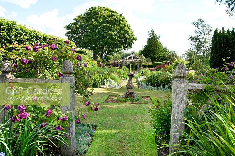 View through Alice's Garden to The Sundial Garden and Llanhydrock Garden beyond at Wollerton Old Hall Garden, Shropshire.