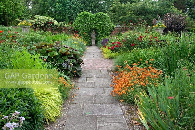 Path through the hot borders in the Llanhydrock garden at Wollerton Old Hall Garden.