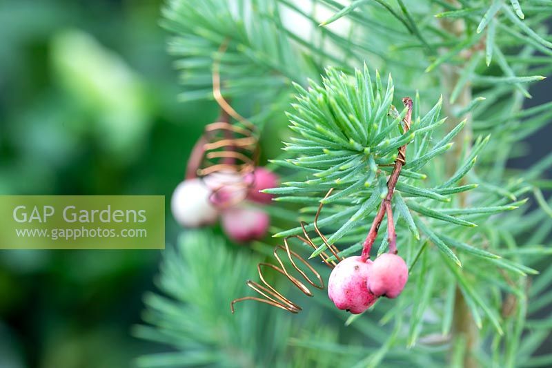 Pink rowan berry hanging christmas decorations using copper wire