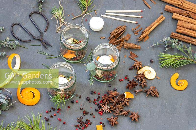 Tools and material for making scented decorative candles in glasses at Christmas